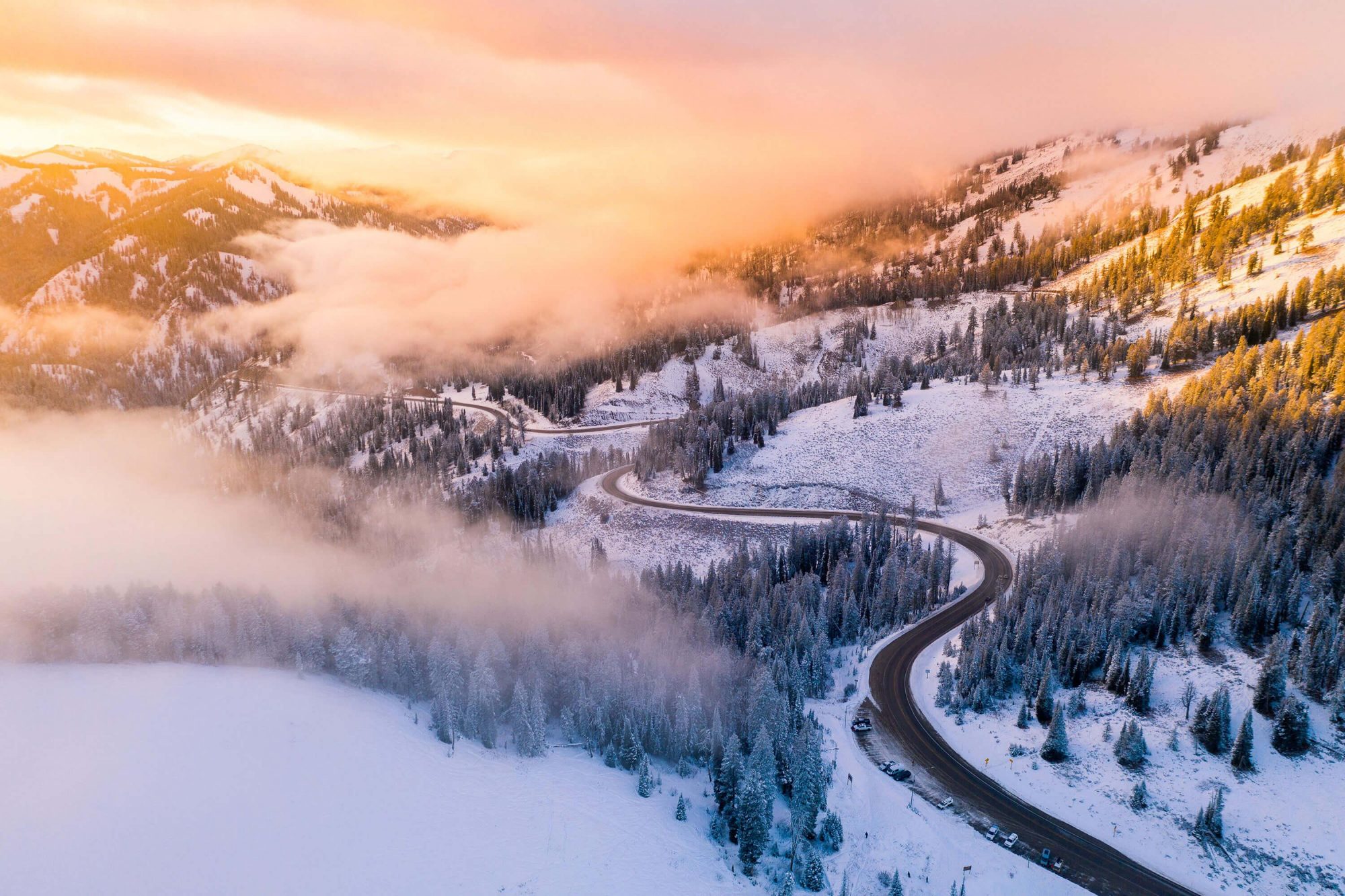 dji drone photo snowy mountain road near jackson wyoming during sunset | photo by jake landon schwartz