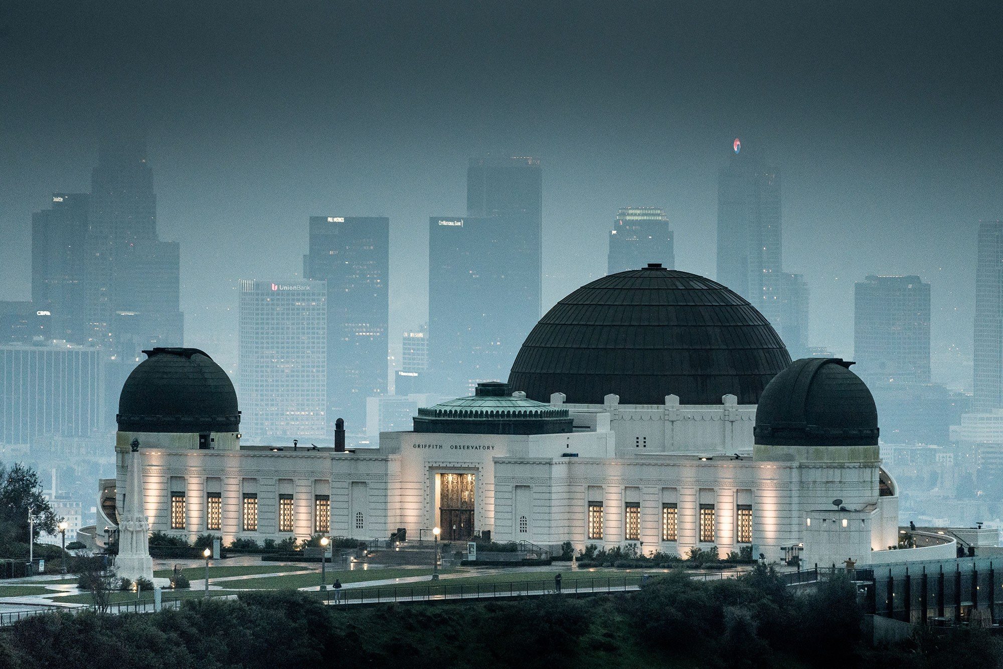 the griffith observatory at sunrise in front of a foggy downtown los angeles california | photo by jake landon schwartz