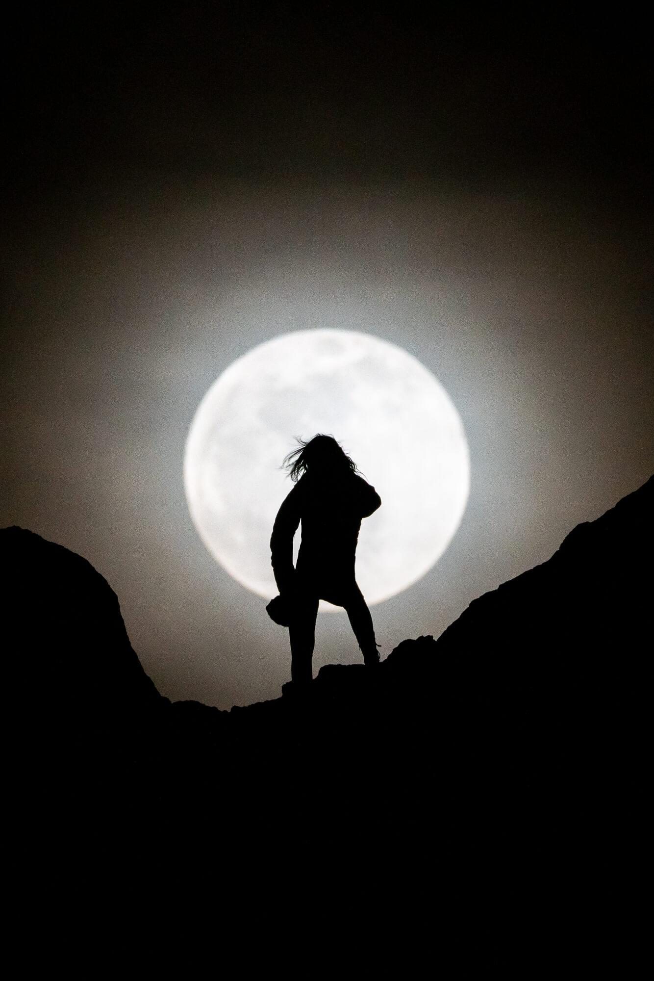 silhouette of a woman during a full moon at trona pinnacles in california | photo by jake landon schwartz