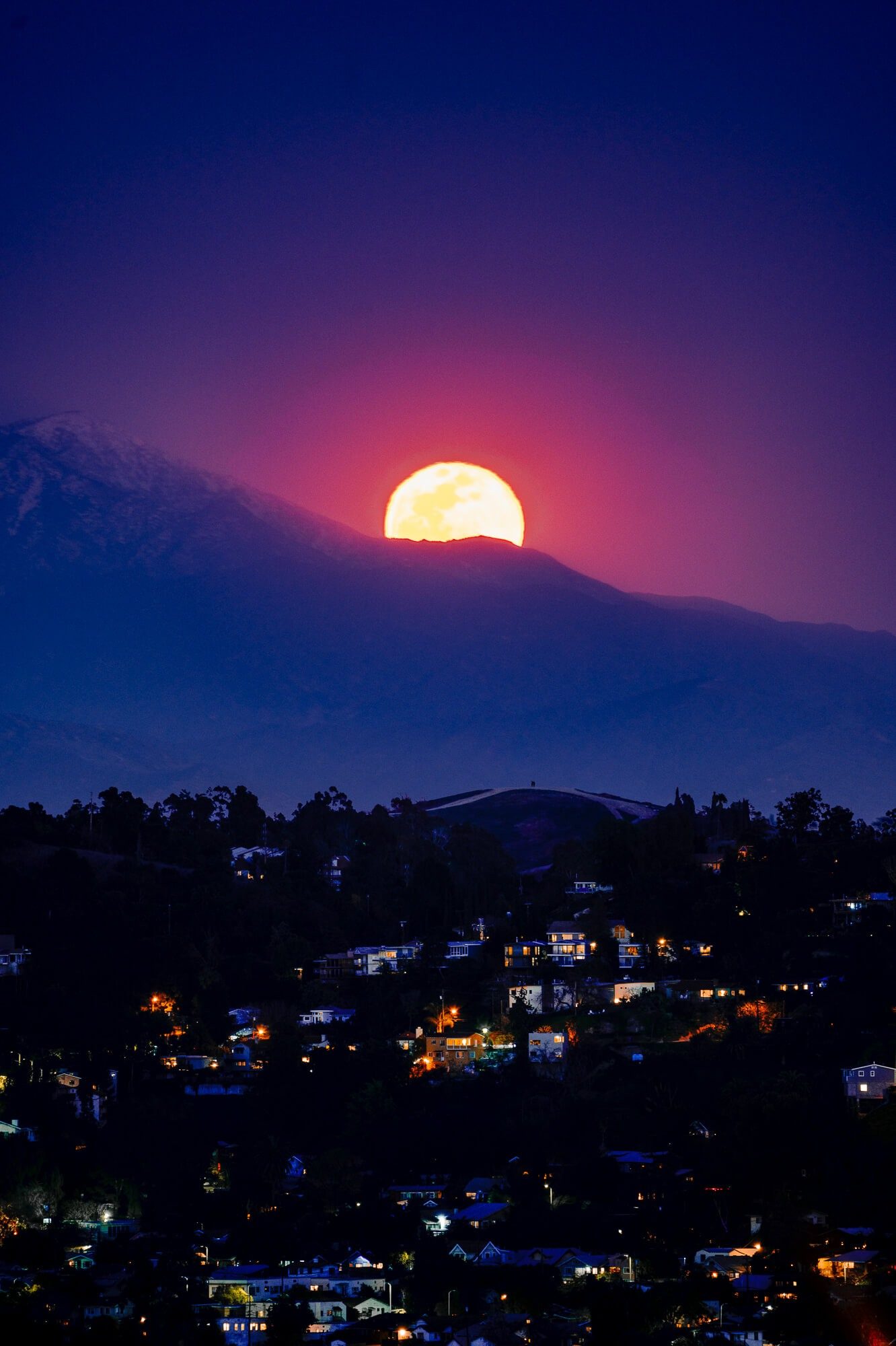 a full moon rise over the san gabriel mountain range from elysian park | photo by jake landon schwartz