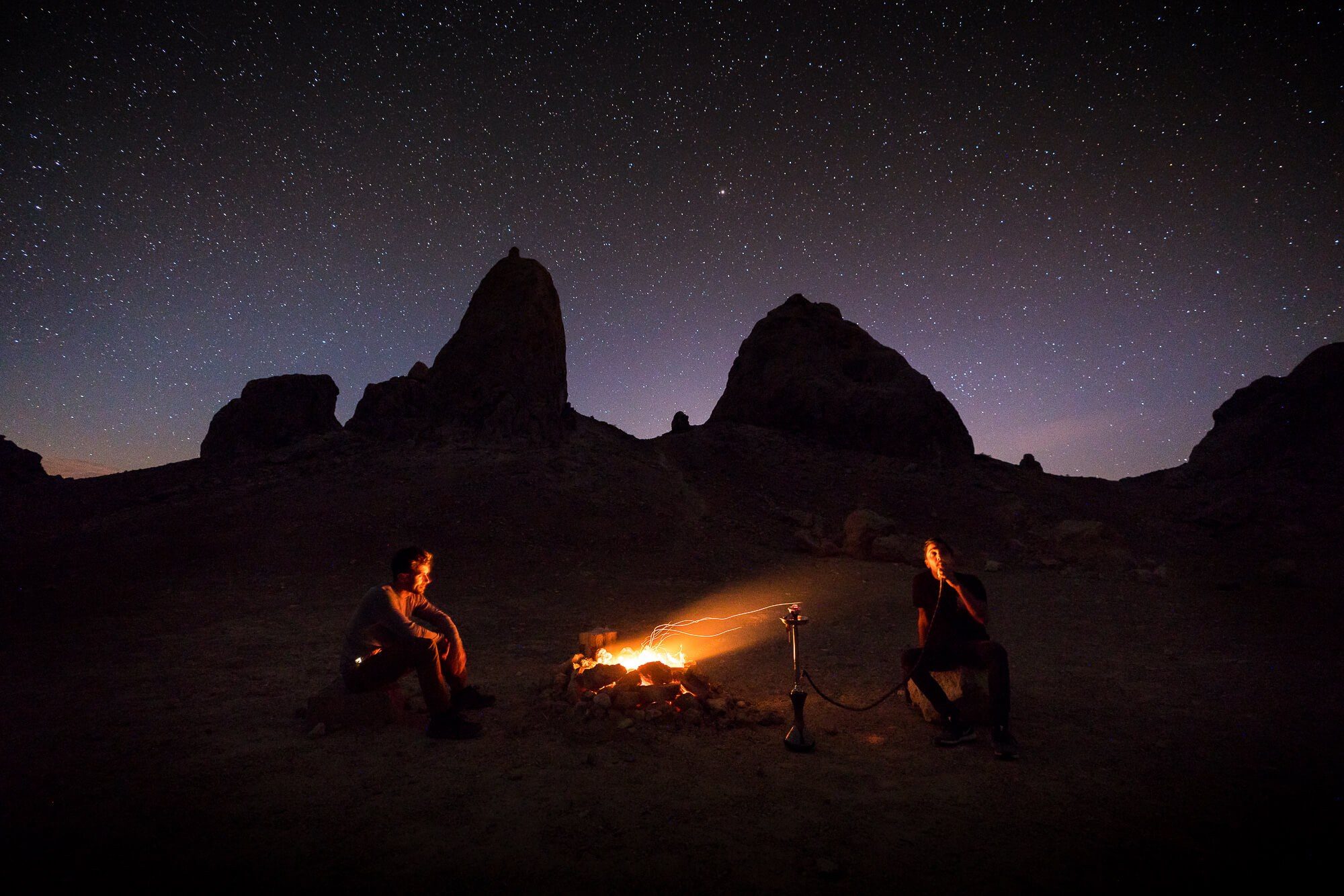 sitting around a camp fire under the stars at trona pinnacles | photo by jake landon schwartz