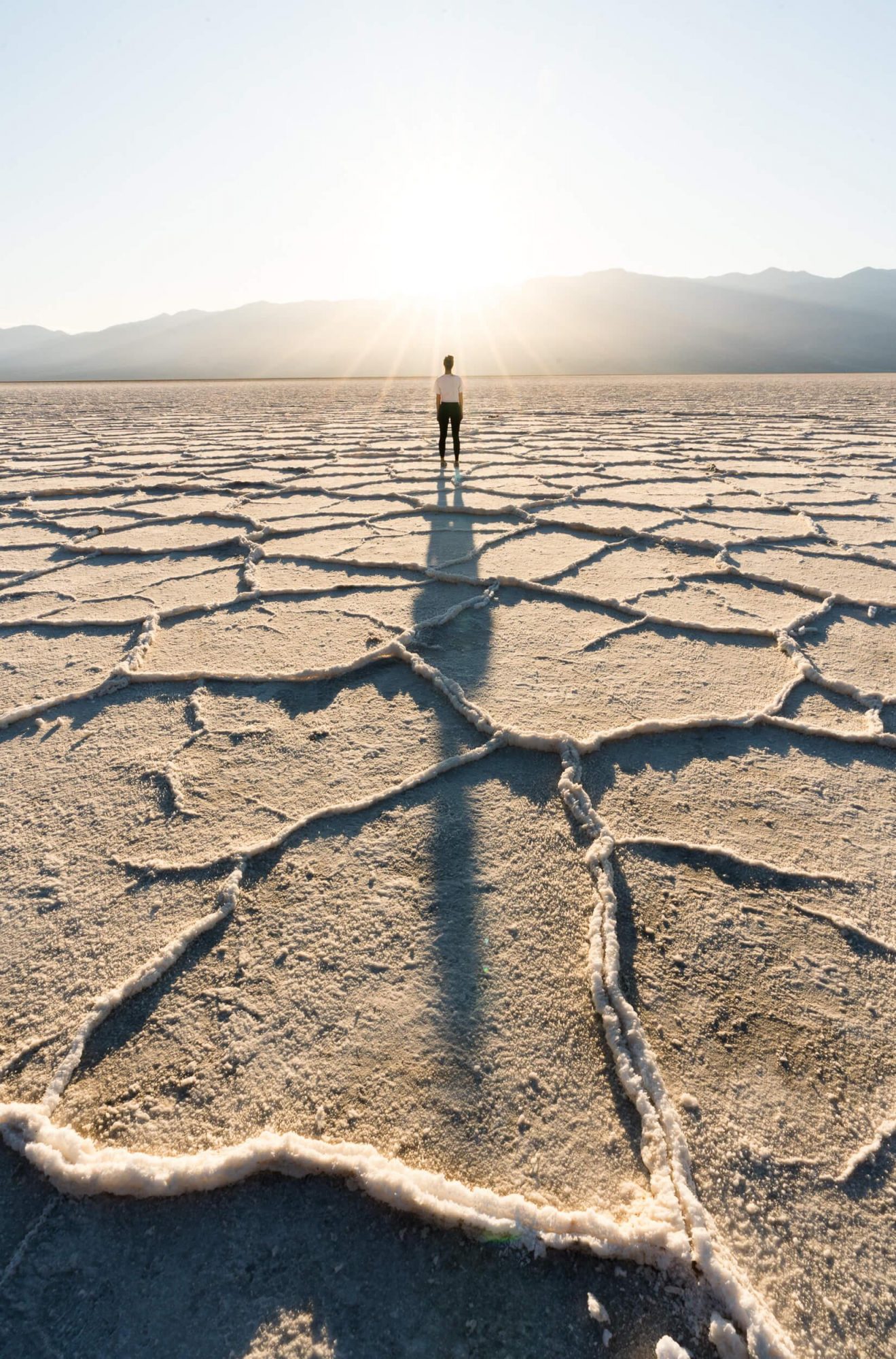 carly wallace stands in awe of the scenery of badwater basin in death valley national park during sunset | photo by jake landon schwartz